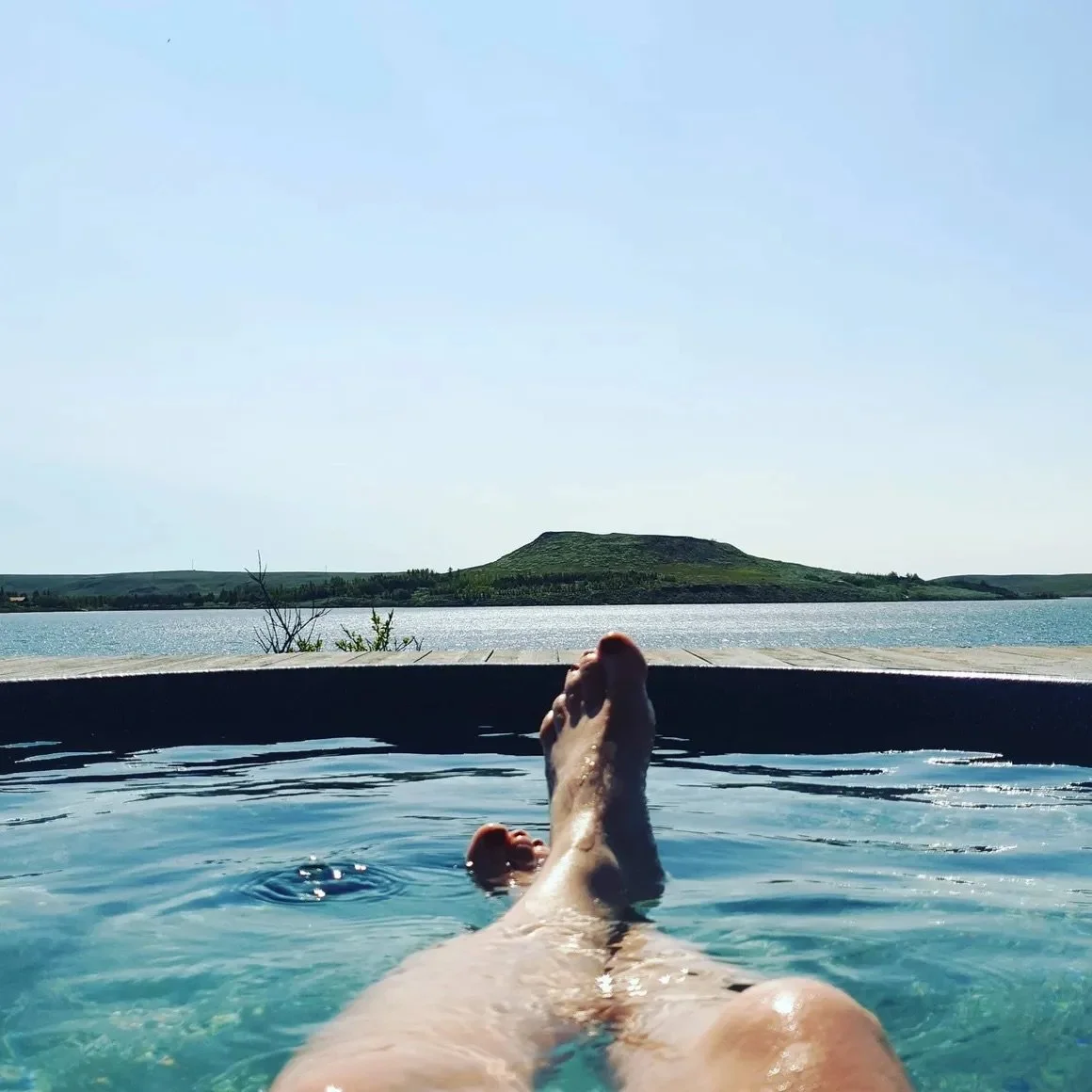 A private soak overlooking the lake