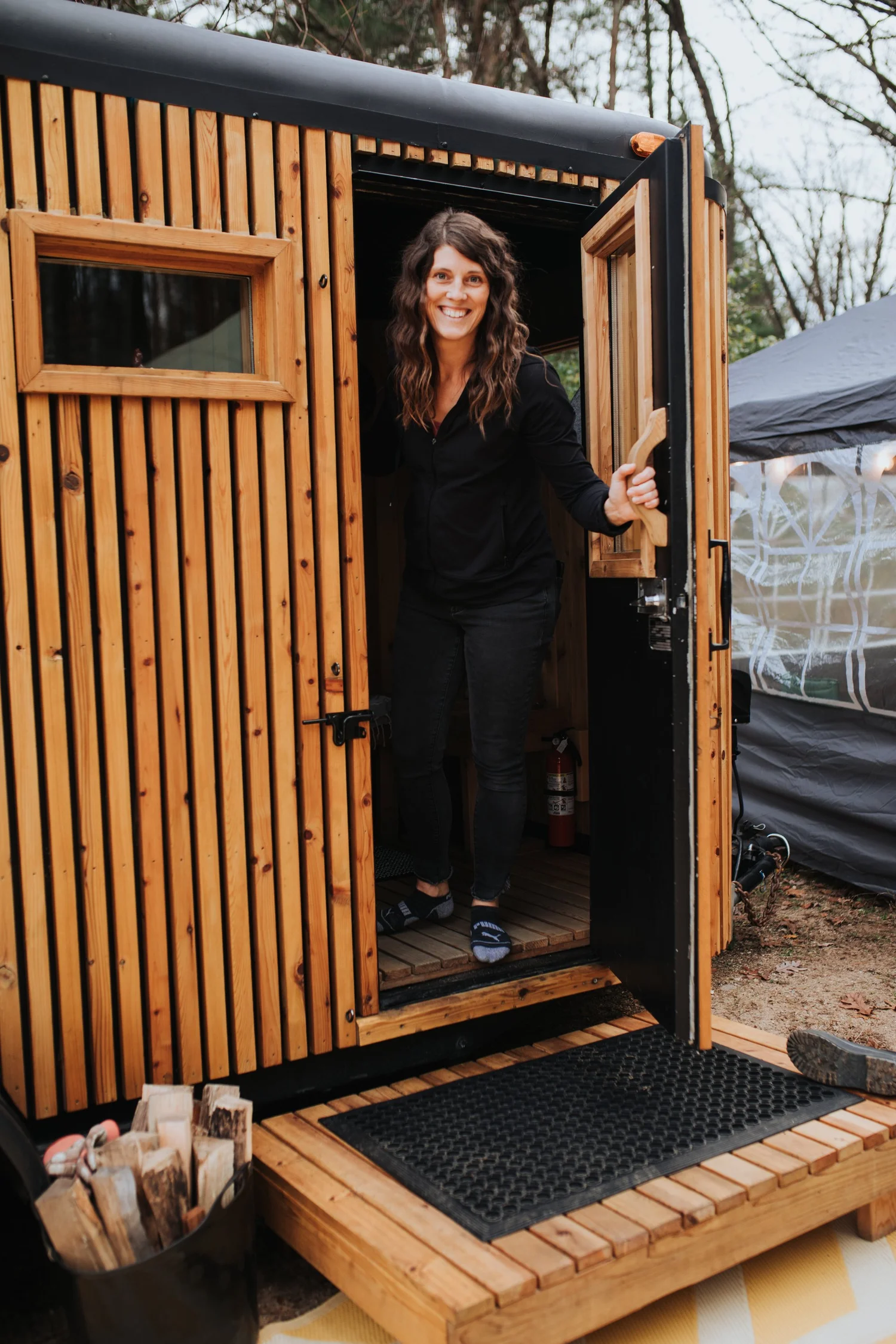 Alisa in the doorway of the mobile sauna